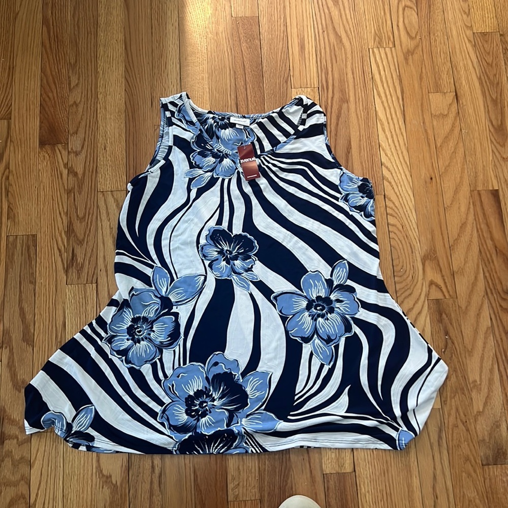 Women’s sleeveless top. Metal detail on the neck.flowy material. Lightweight